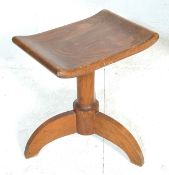 A 1920’s Arts & Crafts Cotswold school solid oak dressing table – country stool. The stool being