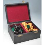 A 20th Century carved chess set having boxwood and ebonised weighted pieces complete with a