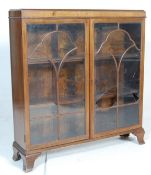 A mid century  1930's walnut Queen Anne style bookcase / display cabinet  vitrine being raised on