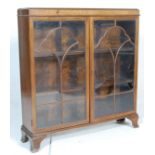 A mid century  1930's walnut Queen Anne style bookcase / display cabinet  vitrine being raised on
