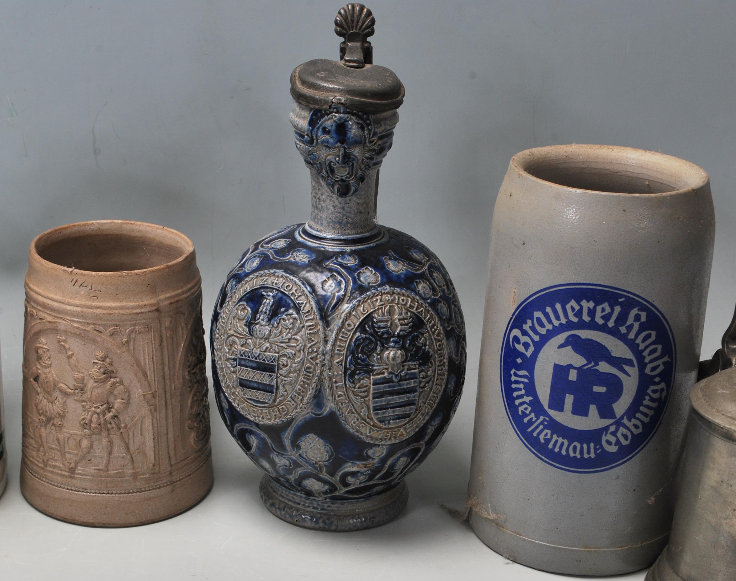 A large collection of German blue and grey stoneware jugs and beer steins, some having pewter - Image 6 of 10