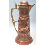A large late 19th Century / early 20th Century German Art Nouveau copper and brass coffee pot by
