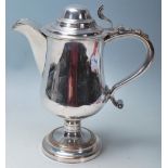 A 19th Century silver plated stylish jug, having scroll handle, bulbous form sitting on a circular