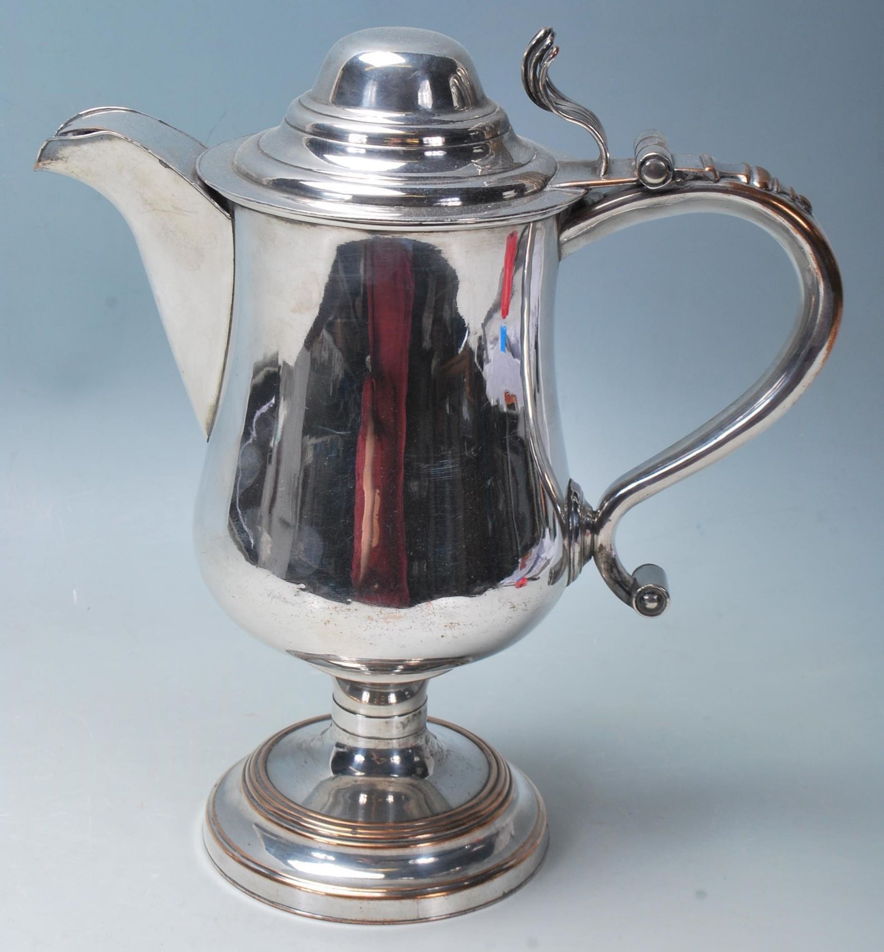 A 19th Century silver plated stylish jug, having scroll handle, bulbous form sitting on a circular