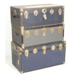 A collection of 3 vintage large early to mid 20th Century American canvas steamer / travel trunks.