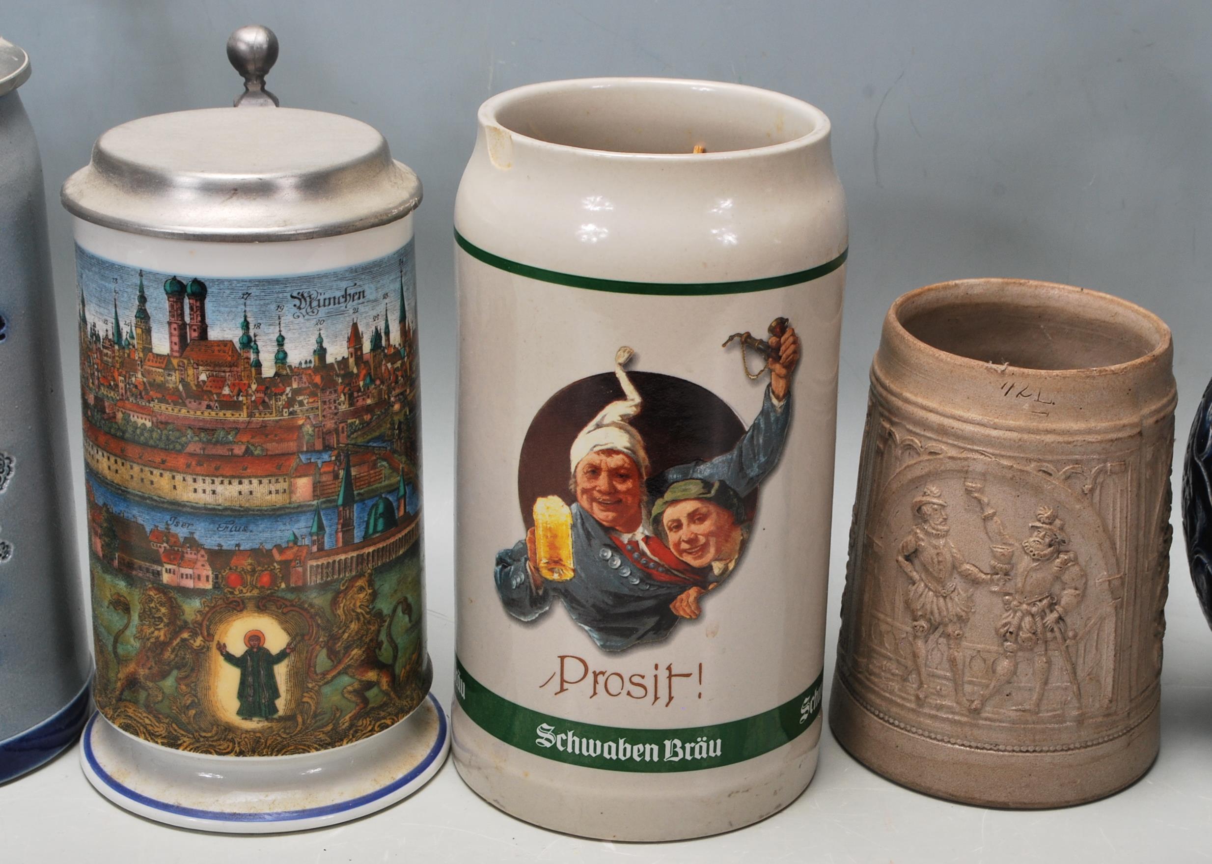 A large collection of German blue and grey stoneware jugs and beer steins, some having pewter - Image 5 of 10