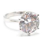 A stamped .925 silver ladies dress ring having a central large round cut CZ set within a prong