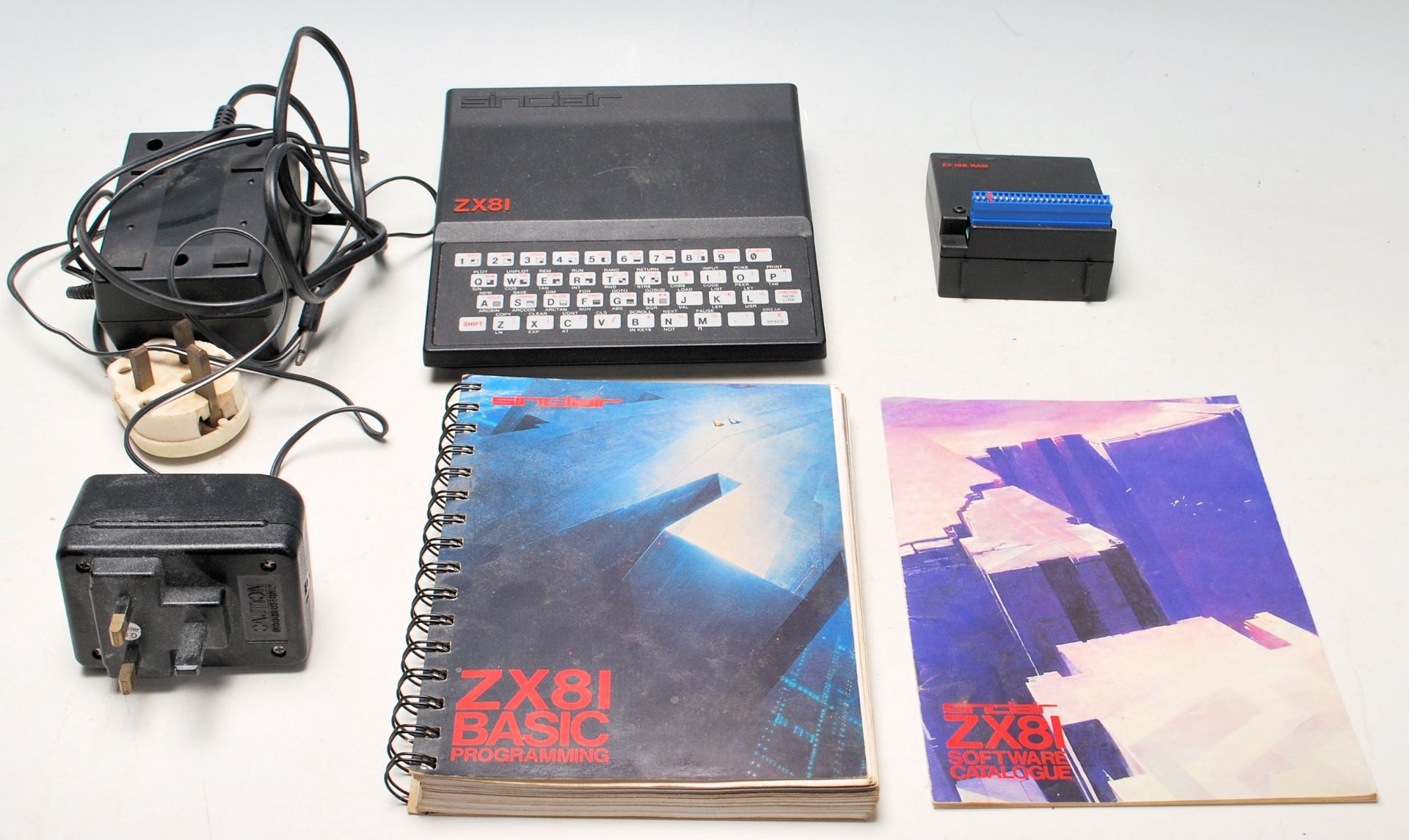 A retro vintage Sinclair ZX81 Computer, with a 16K RAM upgrade and power pack. Together with a