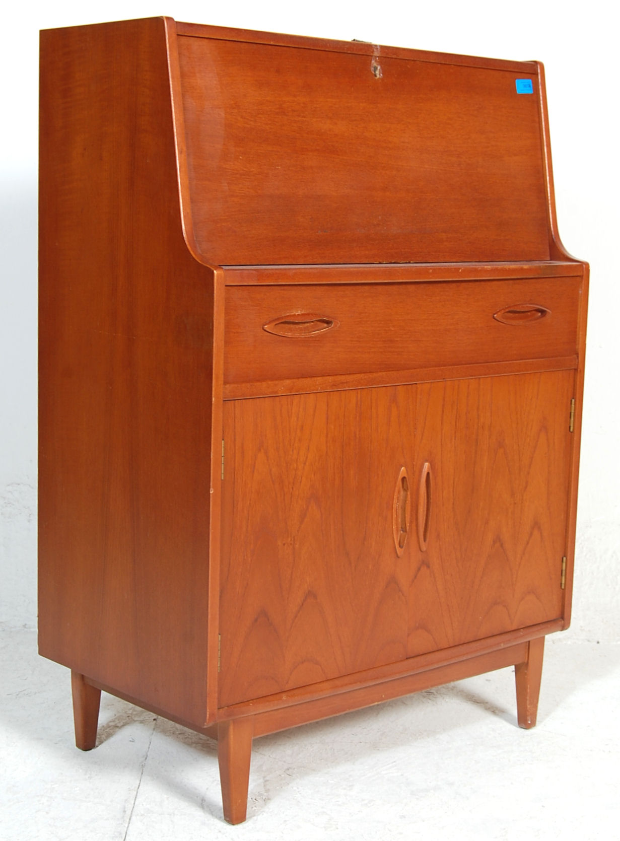 A retro 20th century Danish influence teak wood bureau office desk. The bureau having a fall front