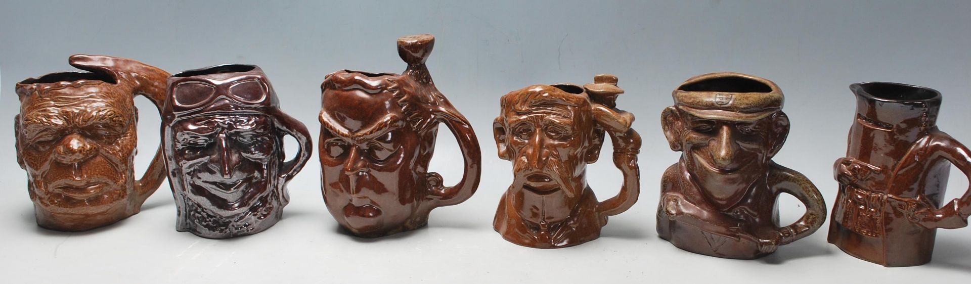 A group of six Australian Bendigo studio art ceramic pottery limited edition character mugs to