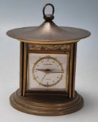 A vintage retro Europa Japanese style small silver plated clock of oval form with raised crane and