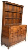 A 20th Century Old Charm style oak dresser having open fronted three open fronted shelves to the