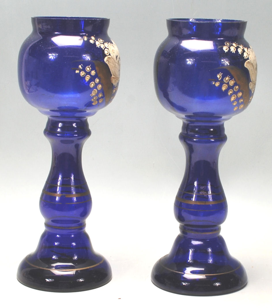 A pair of early 20th Century Bristol Blue vases hand painted with flowers and gilded detailing. - Image 2 of 6