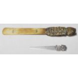 A 20th century silver letter opener having a Egyptian decoration to the handle together with a brass