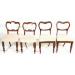 A harlequin set of four Victorian 19th century rosewood dining chairs having white fabric