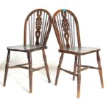 A pair of 19th Century Victorian elmwood wheelback Windsor dining chairs. The chairs  with elm