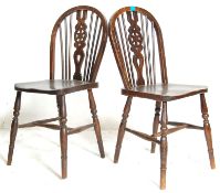A pair of 19th Century Victorian elmwood wheelback Windsor dining chairs. The chairs  with elm