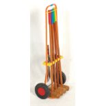 A mid century retro vintage 1950s portable croquet set having multi coloured croquet mallets,