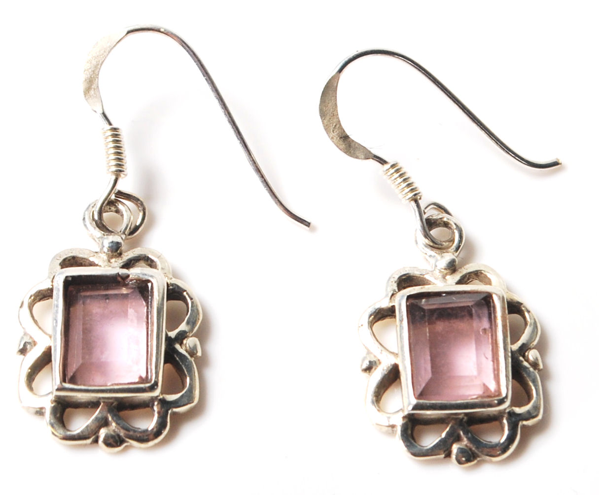 A pair of sterling silver and amethyst art deco style earrings having floral edges and a rectangular