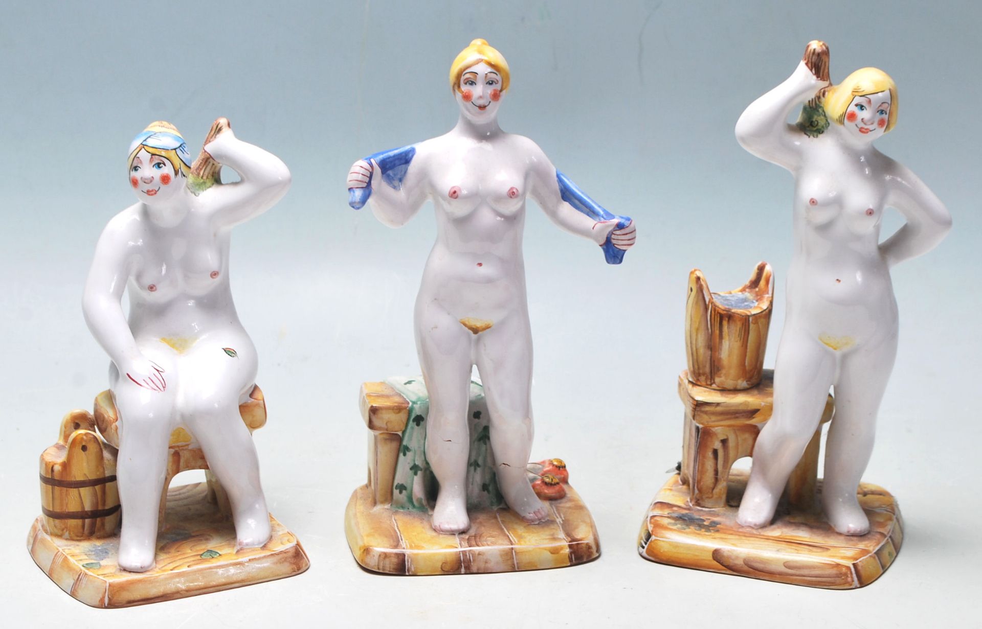 A group of three 20th Century ceramic Russian figurines depicting three stylised nudes ladies each