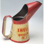A vintage 1950’s Shell Rotella Oil jug having a large beak, oval shaped handle, finished in red
