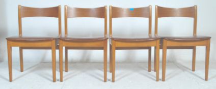 A set of four vintage retro mid century, circa 1970's  teak wood  dining chairs raised on tapering