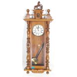 A 20th Century Vienna regulator wall clock in the manner of Gustav Becker having a mahogany glass