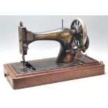 A 19th Century Victorian Singer sewing machine having a black body with gilt decoration