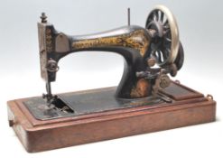 A 19th Century Victorian Singer sewing machine having a black body with gilt decoration