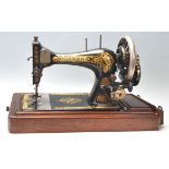 A vintage early 20th Century oak cased Singer Sewing machine having a good art deco sarcophagus