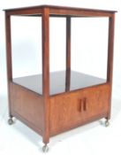 A 1930's Art deco style 2 tier drinks / cocktail trolley in oak. The trolley with a two door