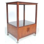 A 1930's Art deco style 2 tier drinks / cocktail trolley in oak. The trolley with a two door
