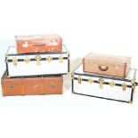 A collection of 5 early 20th Century streamer trunks and suitcases to include 2 vintage leather