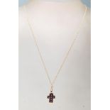 A 9 ct yellow gold and amethyst necklace having a crucifix shaped studded pendant  on a cable