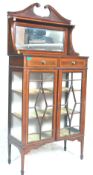 An Edwardian mahogany inlaid mirror back china display cabinet vitrine. The cabinet with twin