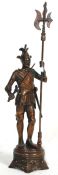 An large 20th century cast metal Wellington statue depicting a medieval soldier holding a sword to