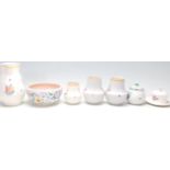 A group of seven vintage Poole Pottery items comprising; a jug, bowl, pair of vases, sugar bowl,