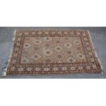 A 20th Century Persian / Islamic floor rug in brown, white and black ground featuring repeating