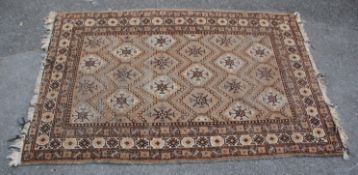 A 20th Century Persian / Islamic floor rug in brown, white and black ground featuring repeating