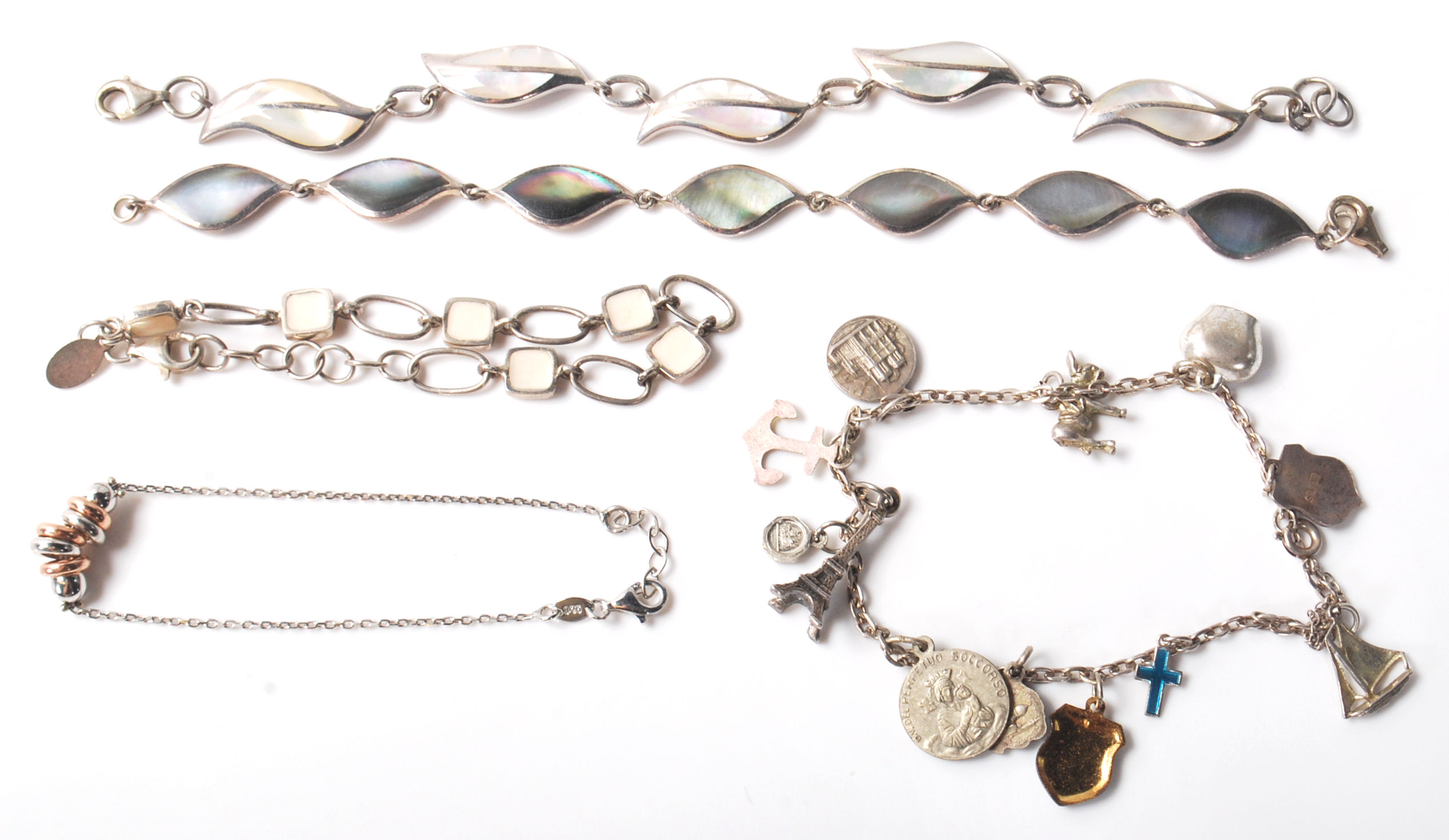 A group of stamped 925 silver bracelets to include two panel bracelets set with mother of pearl