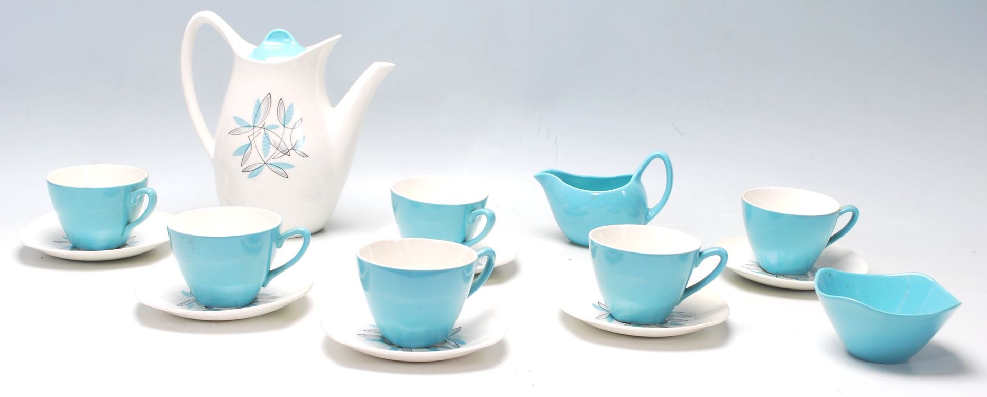 A mid century Midwinter Modern Fashion Shape blue and white coffee set having floral decoration to