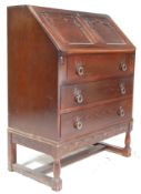 A 20th Century, circa 1930's Jacobean revival oak writing bureau desk having a fall front panelled