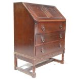 A 20th Century, circa 1930's Jacobean revival oak writing bureau desk having a fall front panelled