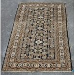 A 20th Century Persian / Islamic rug in brown, green white and black featuring highly decorative