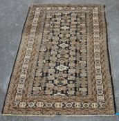 A 20th Century Persian / Islamic rug in brown, green white and black featuring highly decorative