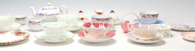 A collection of part china tea sets and cup and sauces to include Royal Albert Country Roses,