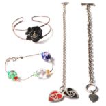 A group of silver ladies bracelets to include a split band band with a black enamelled flower (