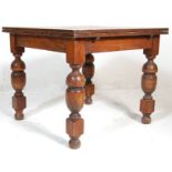 A 1920's early 20th Century oak draw leaf dining table. The table having a panelled oak extending