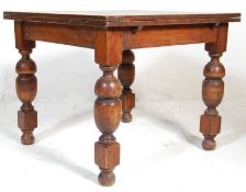 A 1920's early 20th Century oak draw leaf dining table. The table having a panelled oak extending