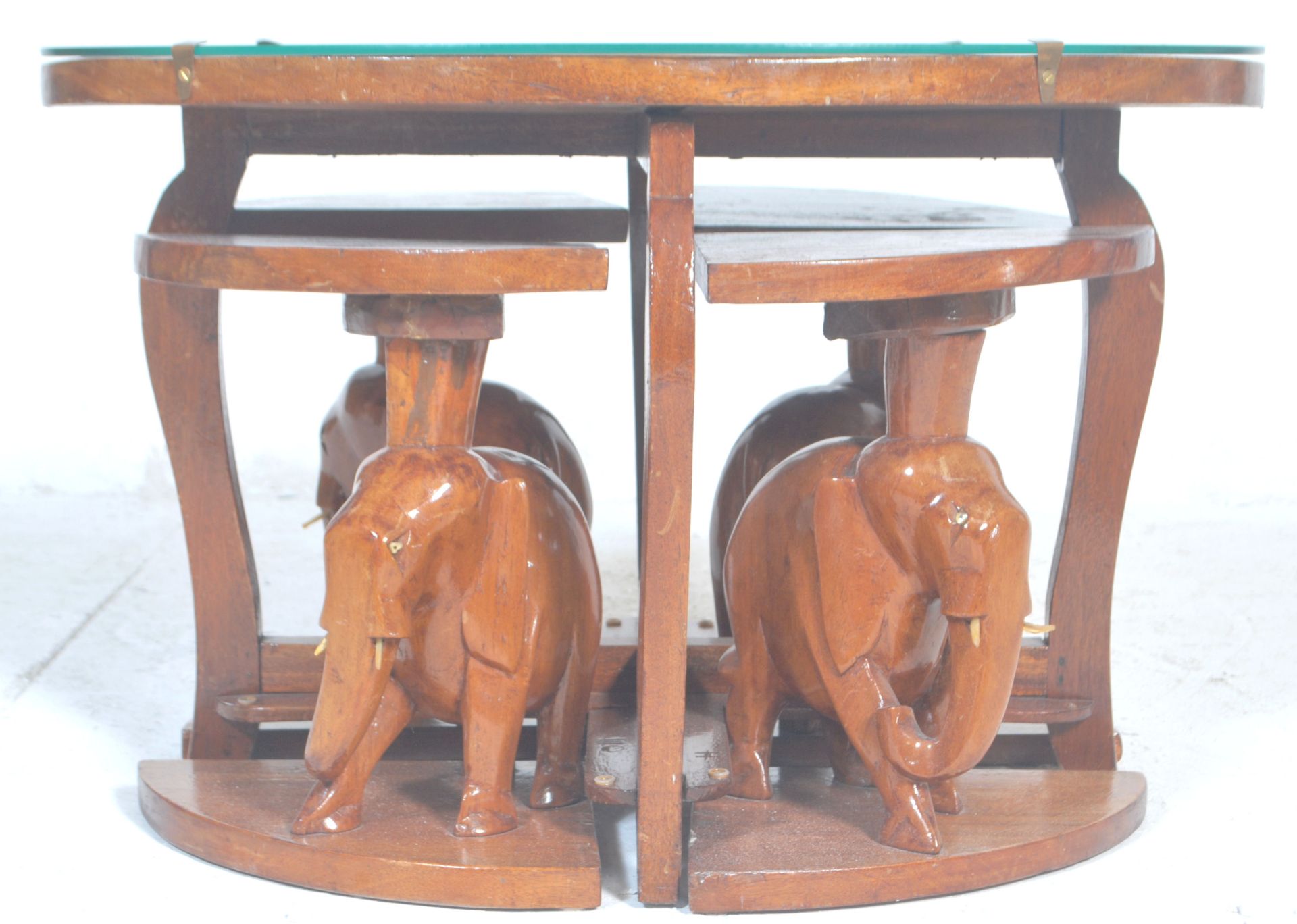 A vintage 20th Century African tribal carved wooden nest of tables having a carved top depicting a - Bild 2 aus 7